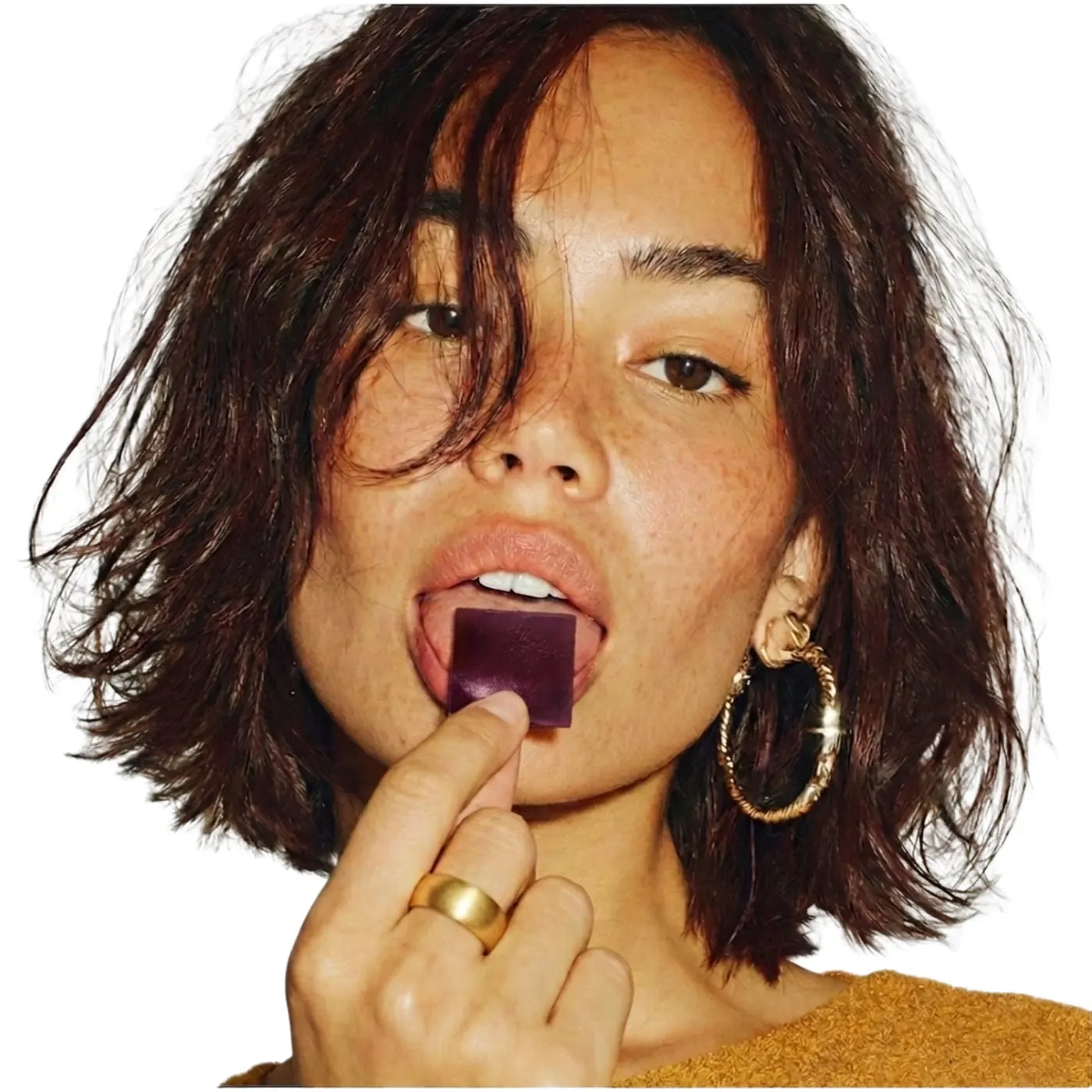 Woman placing a KYVA dissolvable strip on her tongue